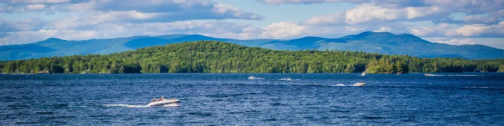 Boats on Lake Winni with the mountains in the background during the summer.